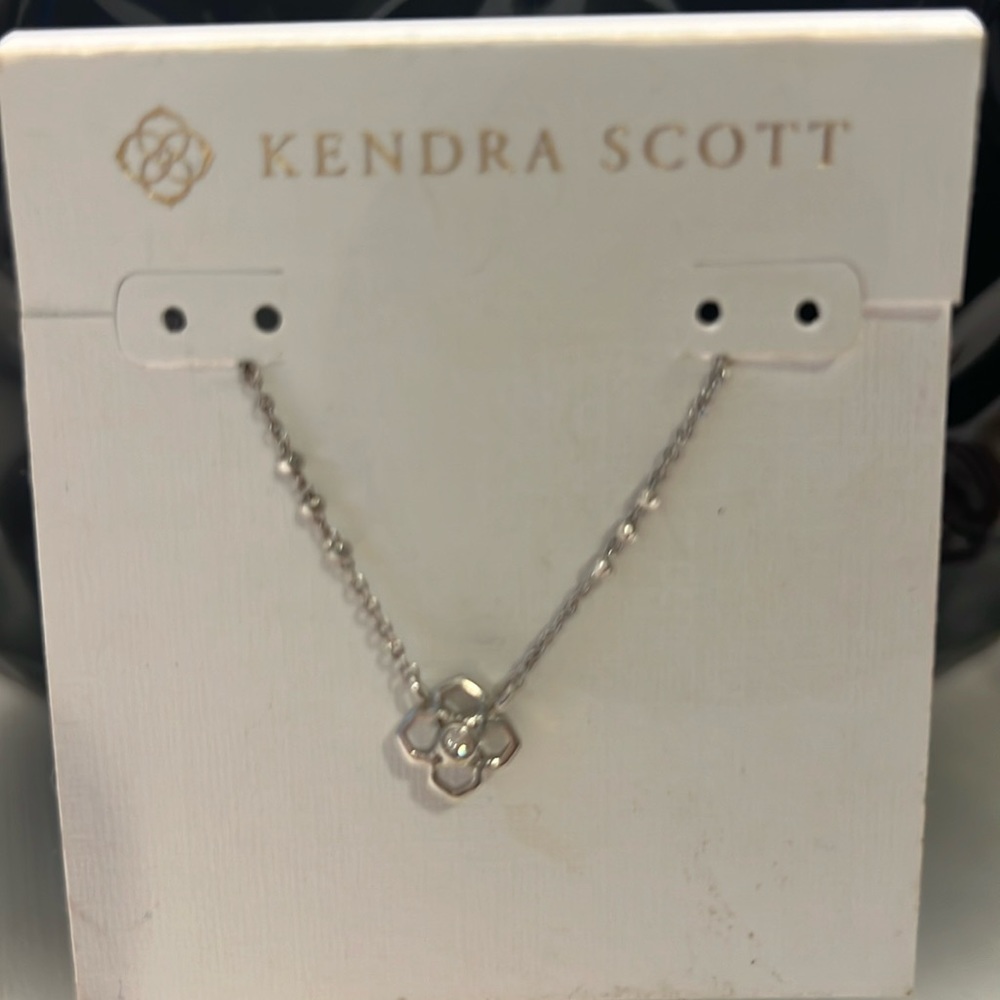 Kendra got silver delicate necklace with a flower